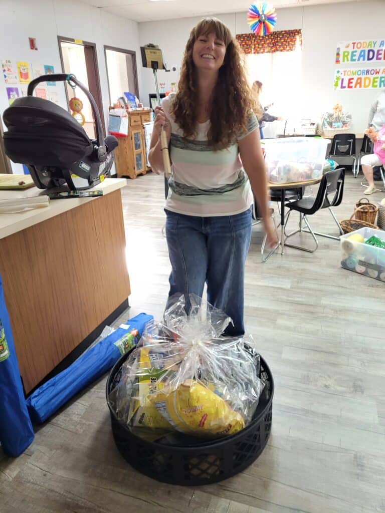 Mrs. Pricilla Bradshaw posing for a photo while building a fundraising basket